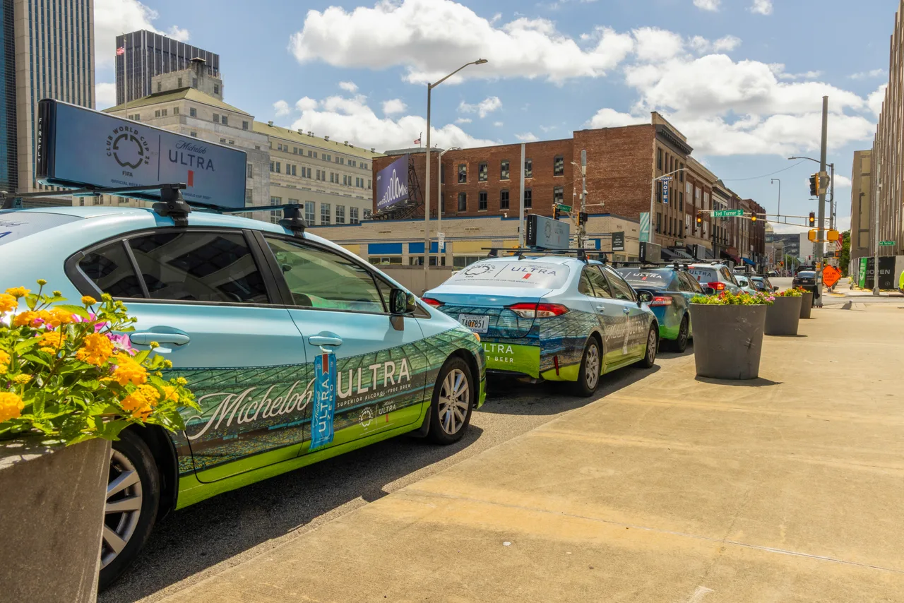 AB InBev campaign on a Firefly 360 wrap + digital top vehicle in Atlanta
