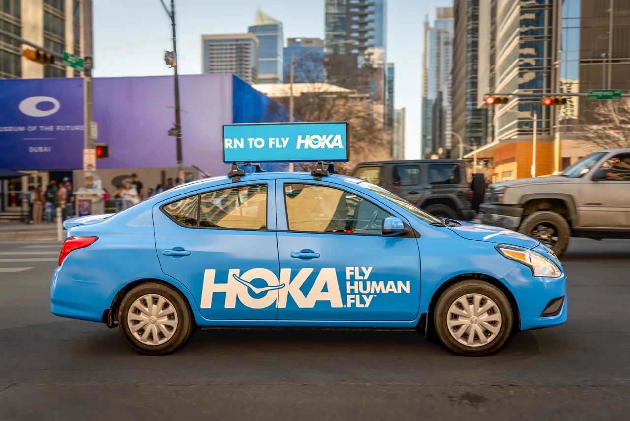 HOKA campaign on a Firefly 360 wrap + digital top vehicle in Austin, 2025