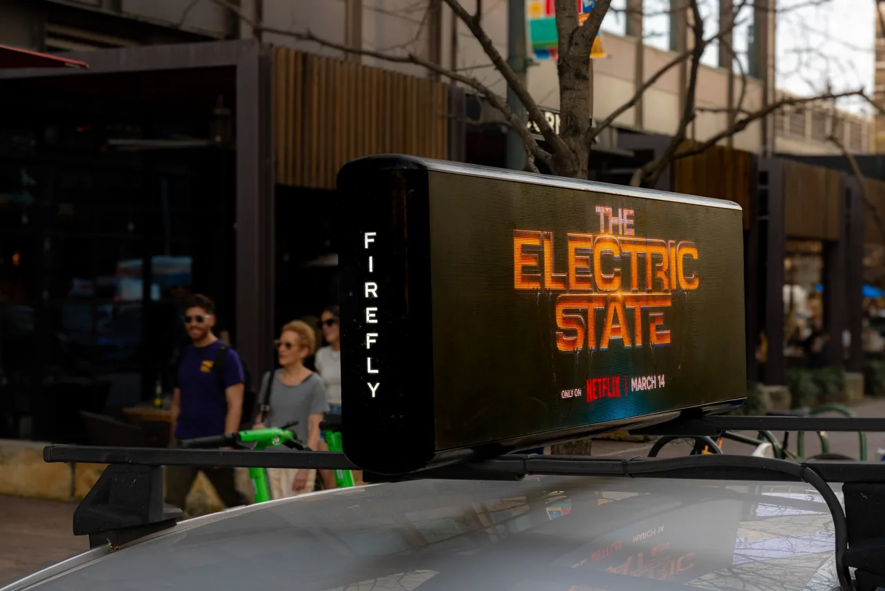 The Electric State campaign on a Firefly digital top + swarm vehicle in Austin, 2025