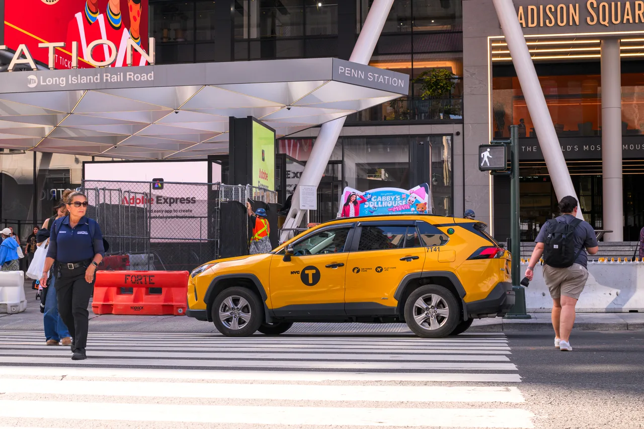 Static illuminated car top display running a Gabby's Dollhouse campaign on a vehicle in city traffic